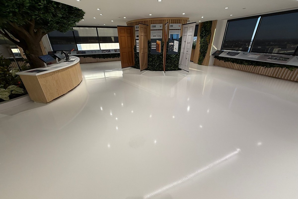 Glossy white epoxy floor in a commercial showroom